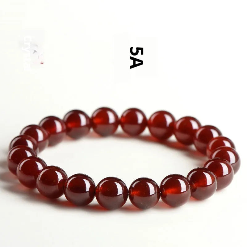 Natural orange red garnet ball bracelet with crystal beads showing ruyi pattern detailing