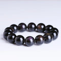 Natural icy obsidian crystal Pi Xiu bracelet with geometric beads on a white background.