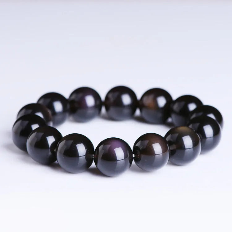 Natural icy obsidian crystal Pi Xiu bracelet with geometric beads on a white background.
