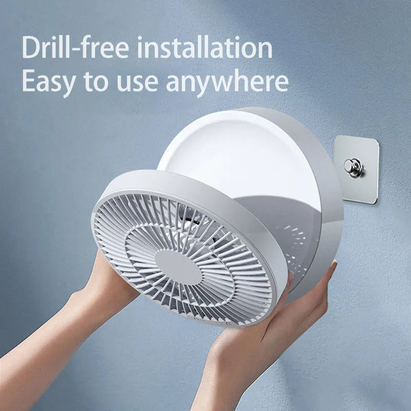 White portable USB rechargeable folding ceiling fan with remote control on desk