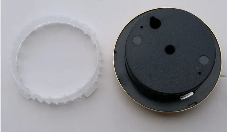 Analog thermometer and hygrometer with aluminium ring and dial showing temperature and humidity scales.