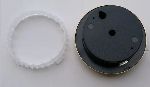 Analog thermometer and hygrometer with aluminium ring and dial showing temperature and humidity scales.
