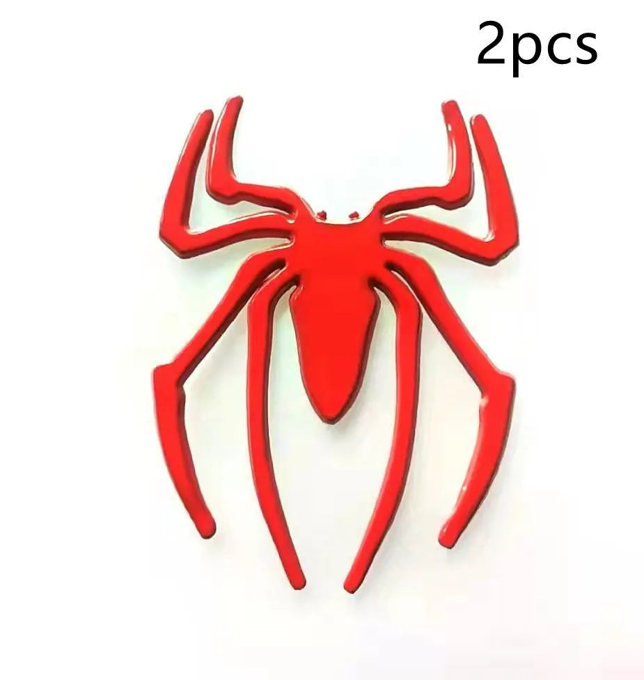 Three-dimensional metal spider sticker in gold colour, measuring 7cm by 5cm.