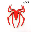 Three-dimensional metal spider sticker in gold colour, measuring 7cm by 5cm.