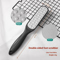 Stainless steel foot grinder tool with white and black double-sided sandpaper files for callus removal.