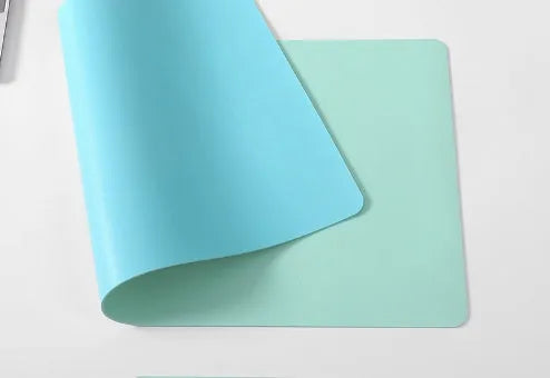 Oversized rubber mouse pad 30x60cm with stitched edges, black colour, on a desk with keyboard and mouse