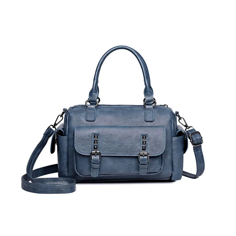 Vintage messenger bag in horizontal square shape showing contrast stitching details and shoulder strap