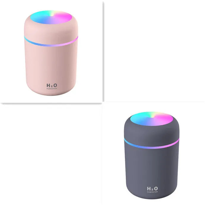 Pink USB portable humidifier with 300ml water tank on wooden desk surface