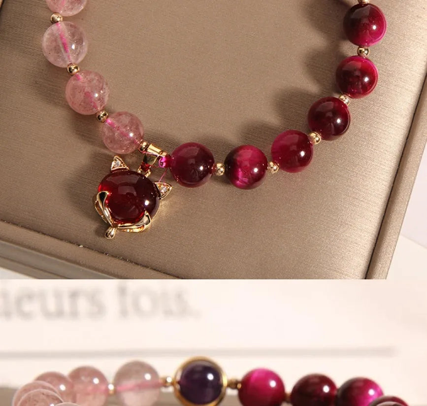 Women's strawberry crystal bracelet on elastic rope showing natural bead texture and uniform 18cm size