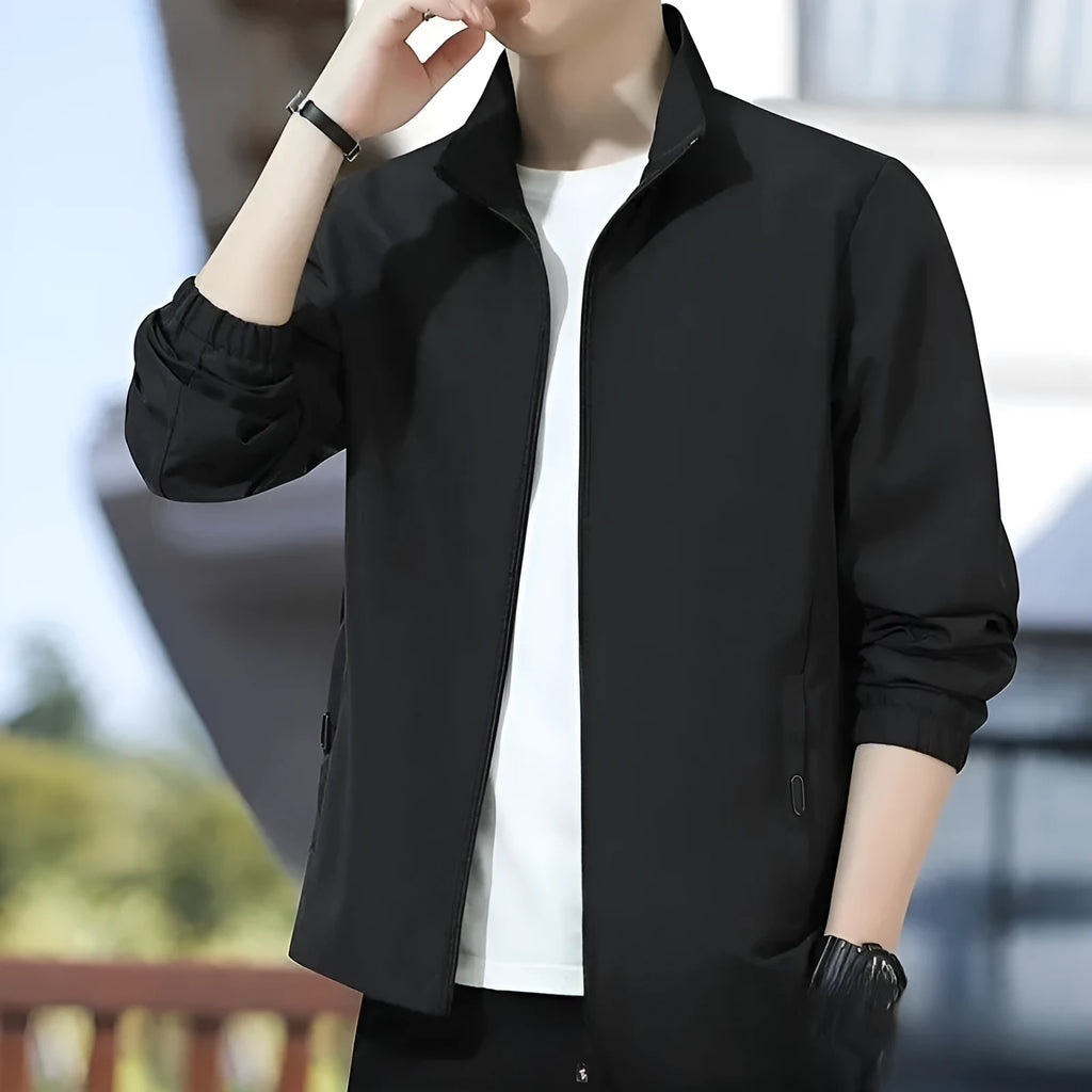 Korean style loose fit casual jacket in black with zip and patch pockets on a man.