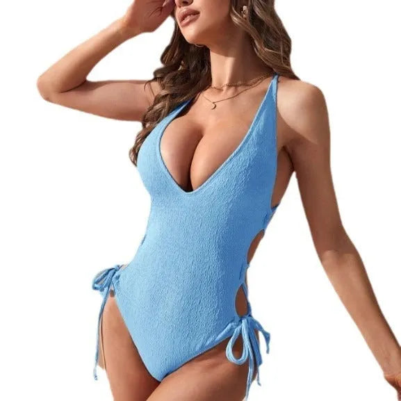 Women's black hollow backless tether bikini one-piece swimsuit laid flat