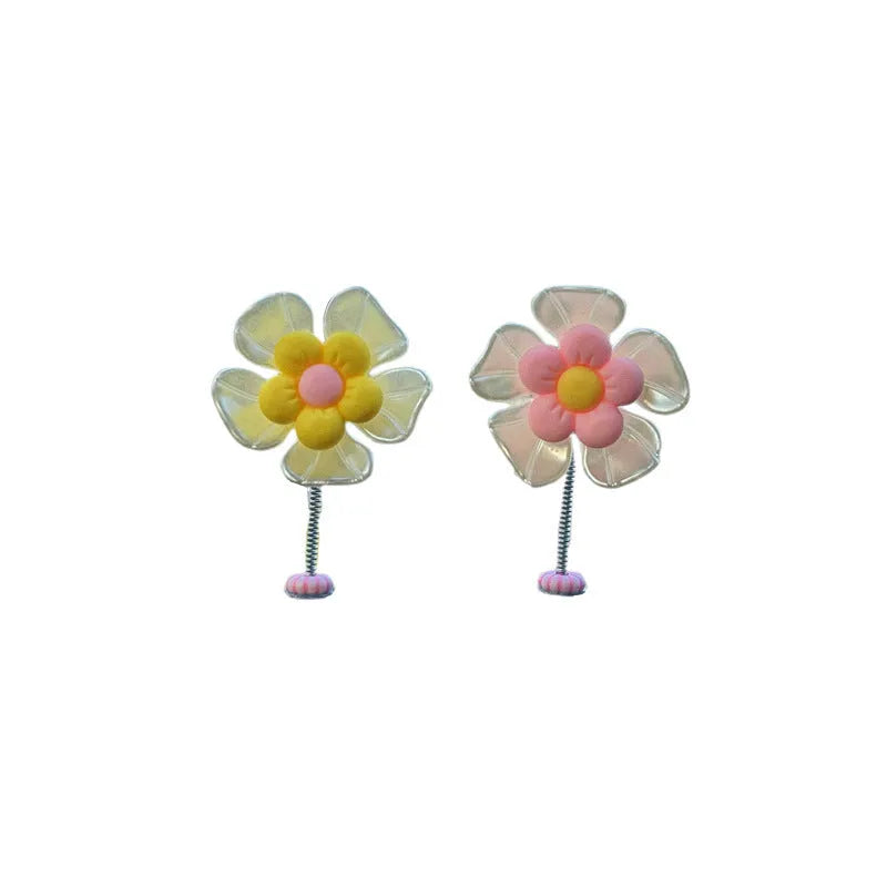 Small colourful plastic swing car decoration ornament in blue, green, pink, purple, or yellow.