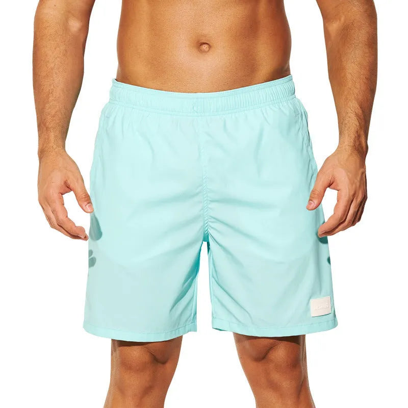 Men's solid colour quick-dry nylon sports shorts on a beach background