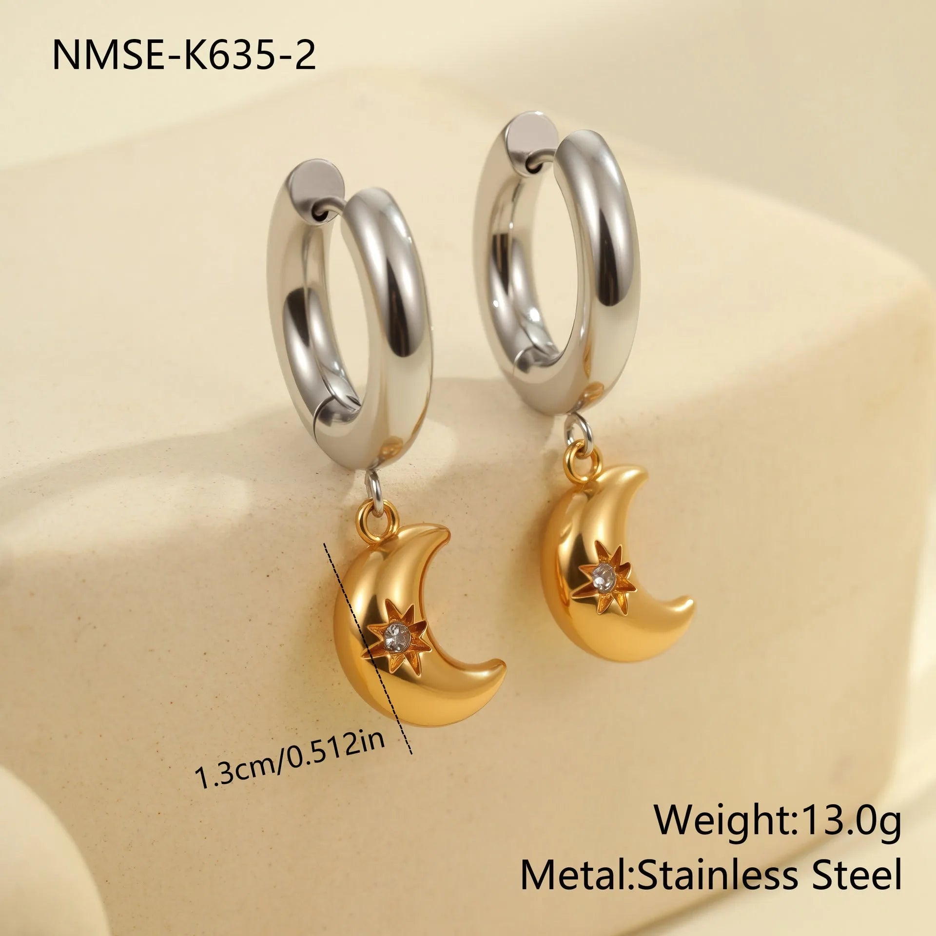 A pair of stainless steel earrings with an 18K gold colour finish, shown in a Christmas tree shape and a heart shape.