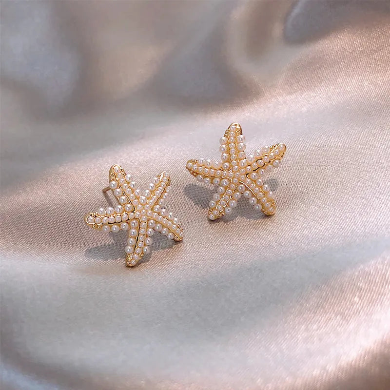 Gold Korean-style alloy earrings with pineapple starfish design and pearl-coloured gem inlays.