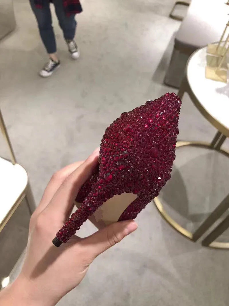Women's gold pointed toe high heels with rhinestone detail and stiletto heel