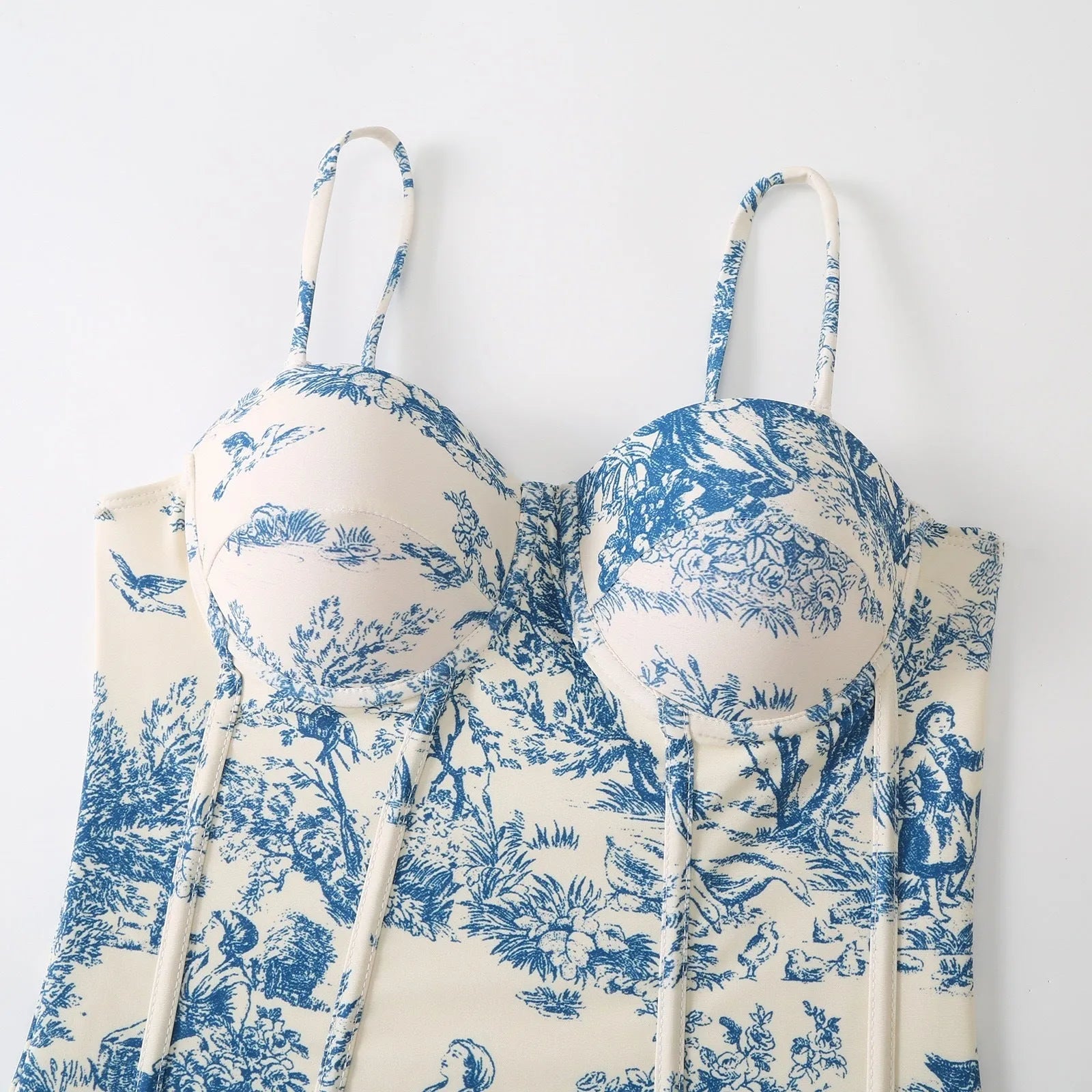 Blue patterned women's one-piece swimsuit with matching gauze skirt on size chart