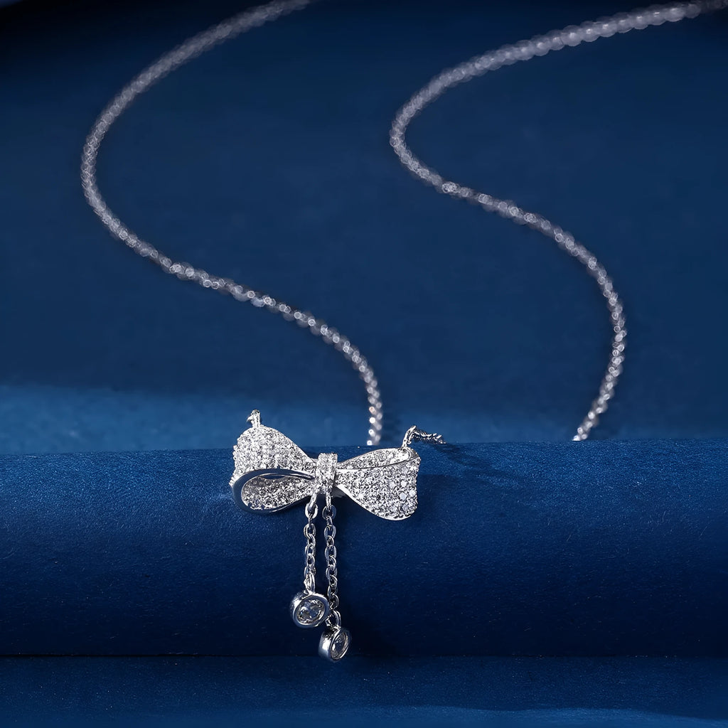 S925 sterling silver necklace with a bow pendant on an adjustable O-ring chain.