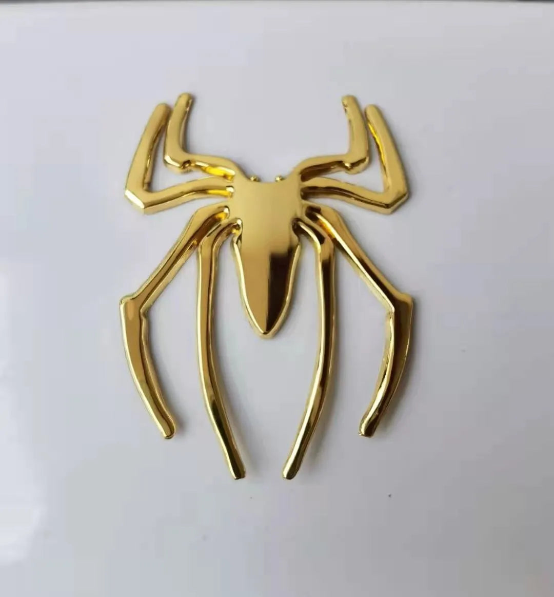 Three-dimensional metal spider sticker in gold colour, measuring 7cm by 5cm.