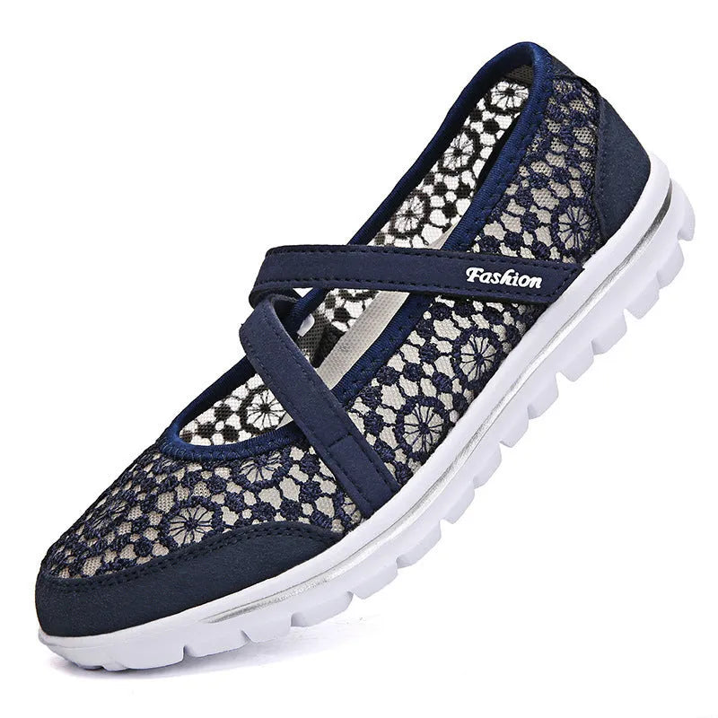 Women's beige lace-up casual flats with mesh upper and round toe on a light background.