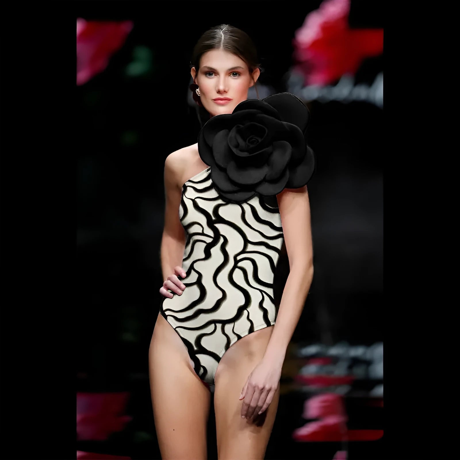 Women's one-piece swimsuit with three-dimensional floral pattern in black and blue colour options.