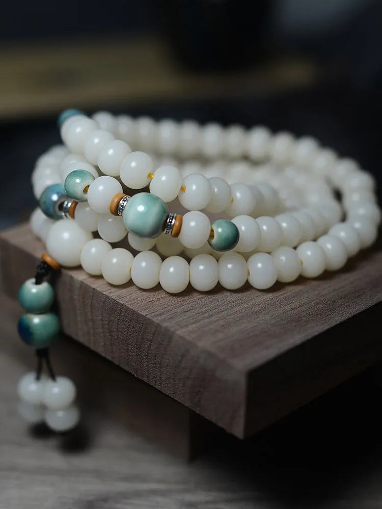 White jade bodhi seed bracelet with 108 flat round beads in 7x9mm and 8x10mm sizes.