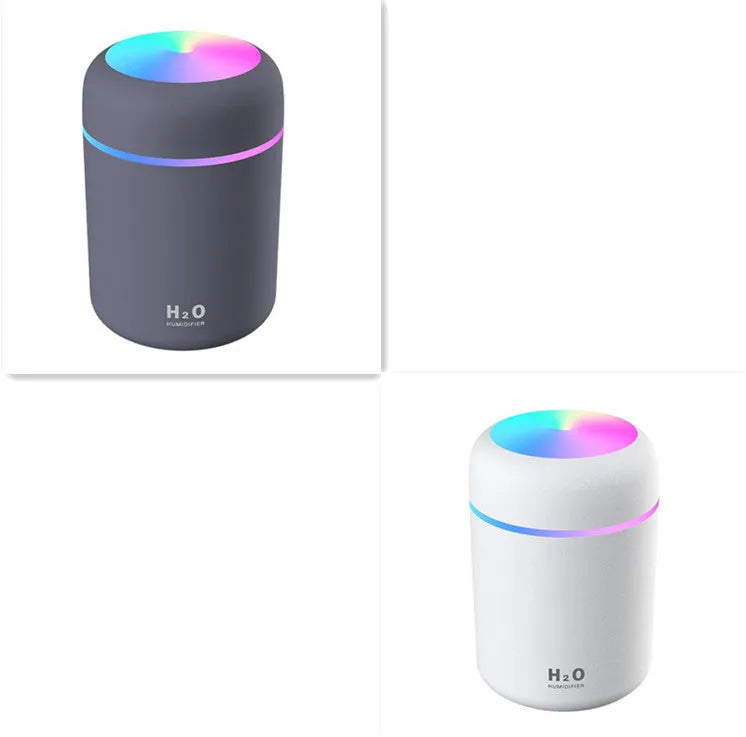 Pink USB portable humidifier with 300ml water tank on wooden desk surface