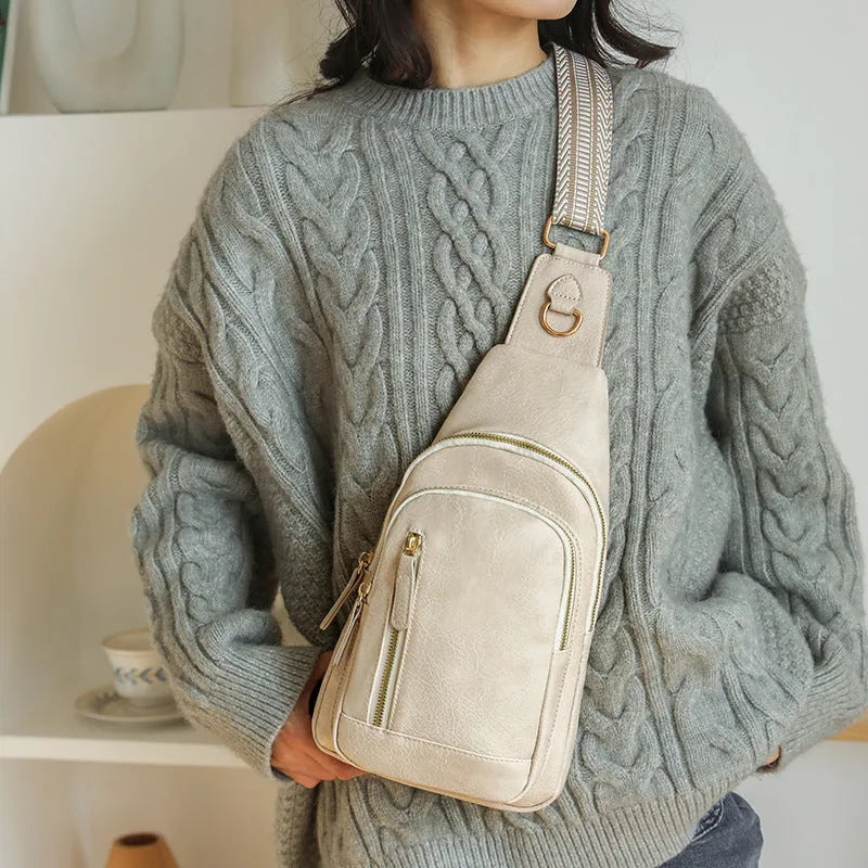 Women's small brown PU leather chest bag with open front pocket worn across chest
