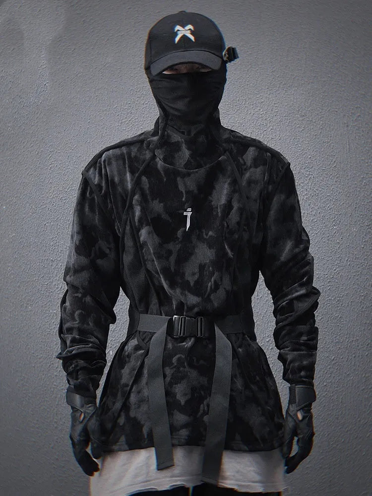 Man wearing a black tie dye printed sweater with a finger turtleneck and drop-shoulder sleeves.