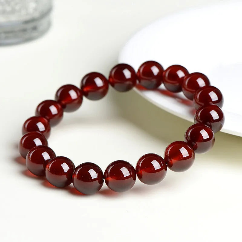 Natural orange red garnet ball bracelet with crystal beads showing ruyi pattern detailing