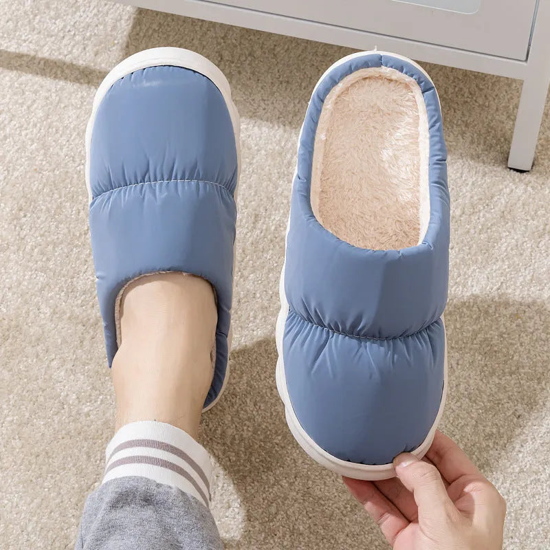 Pair of down cotton indoor slippers with artificial leather upper and thick rubber sole.