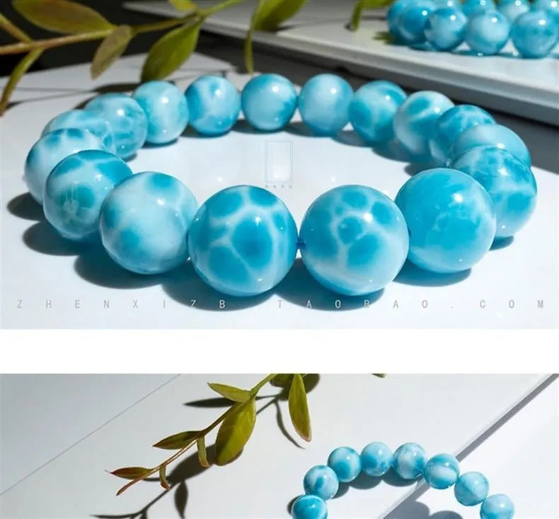 Blue handmade bodhi and pearl bracelet in Maillard style on a neutral background.