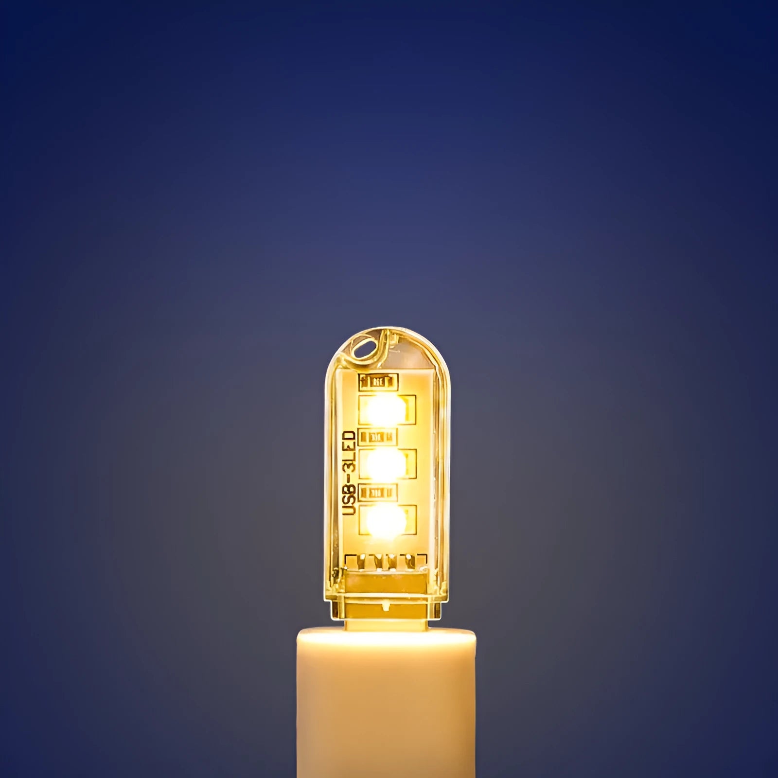 Compact round white LED night light with USB cable, shown with warm and white light illumination.