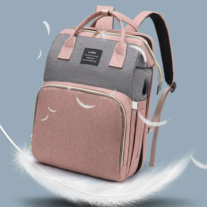 Large capacity insulated baby crib backpack in pink grey with double shoulder straps and outer pocket on white background