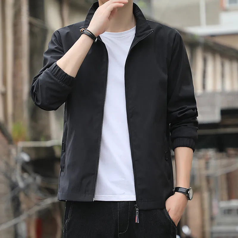 Korean style loose fit casual jacket in black with zip and patch pockets on a man.