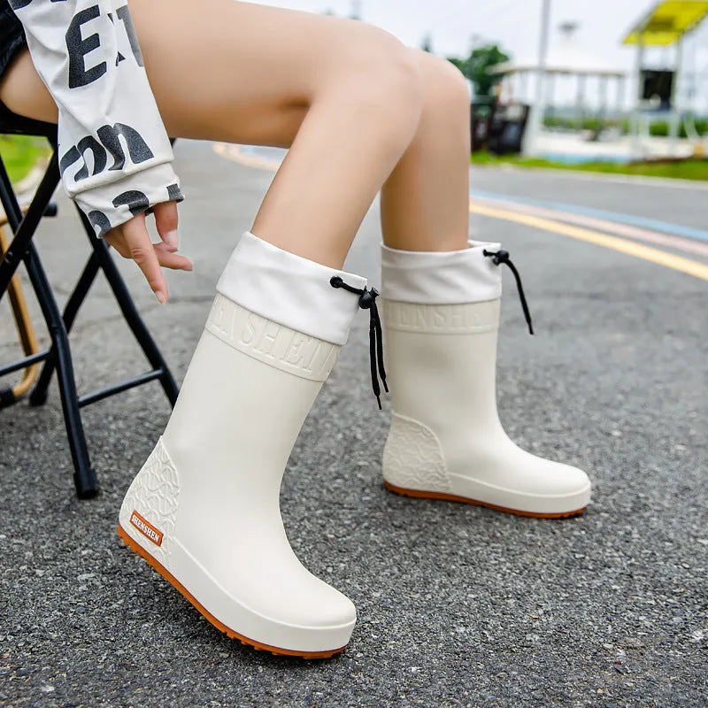 Women's PVC rain boots with non-slip soles in apricot, black, brown, or pink colours