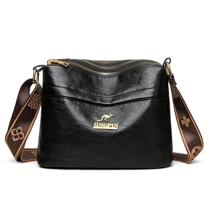 Large capacity multi compartment cross body bag in black with horizontal square shape and sewing thread detail