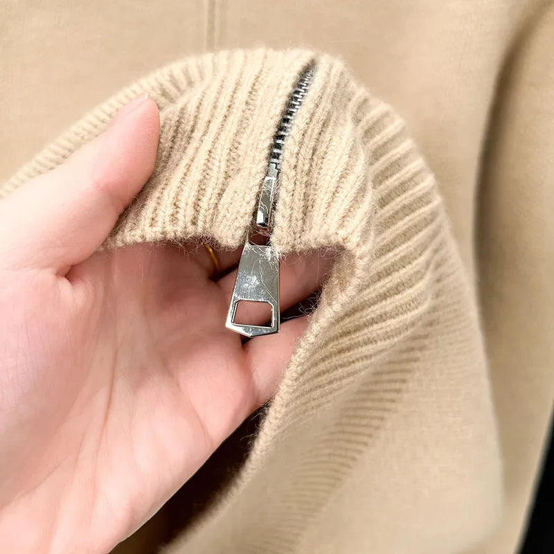 Man wearing a beige high collar zip-front knit cardigan, loose fit, long sleeves.