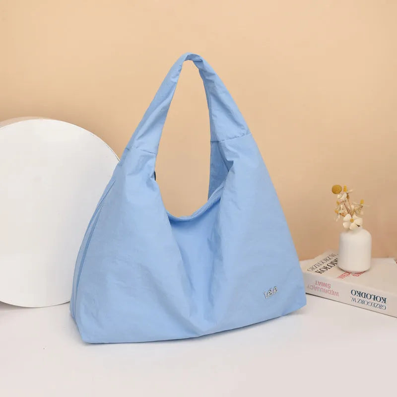 Soft nylon women's underarm bag in a heart shape, shown in black, blue, khaki, and yellow colour options.
