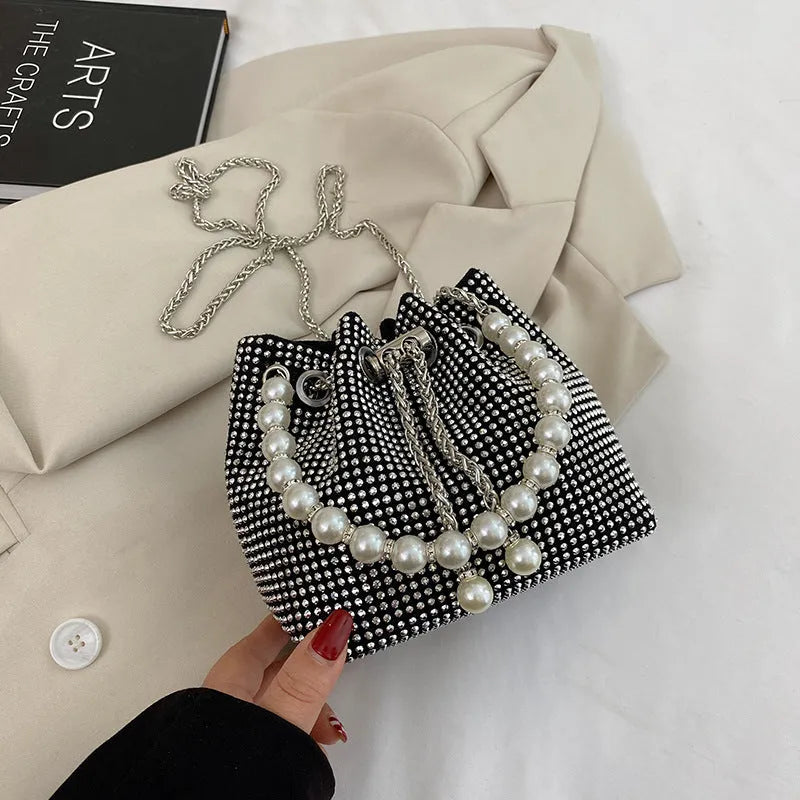 Diamond pattern crossbody bag with chain strap in bucket shape showing internal organisation compartments