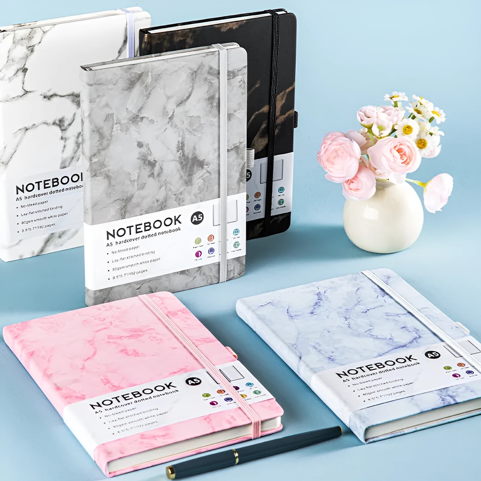 A5 soft touch PU leather diary notebook with strap closure, open to show lined white paper pages