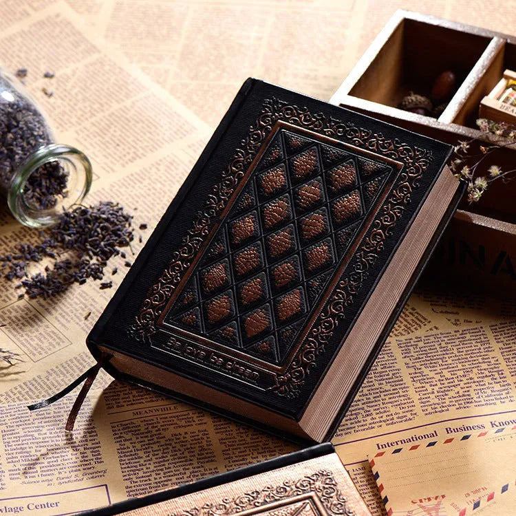 Embossed faux leather notebook in bronze colour, open to show thick white pages.