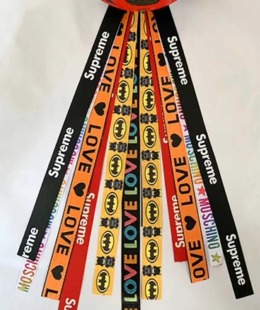 Close-up of a colourful decorative ribbon streamer attached to a child's helmet for roller skating or skiing.