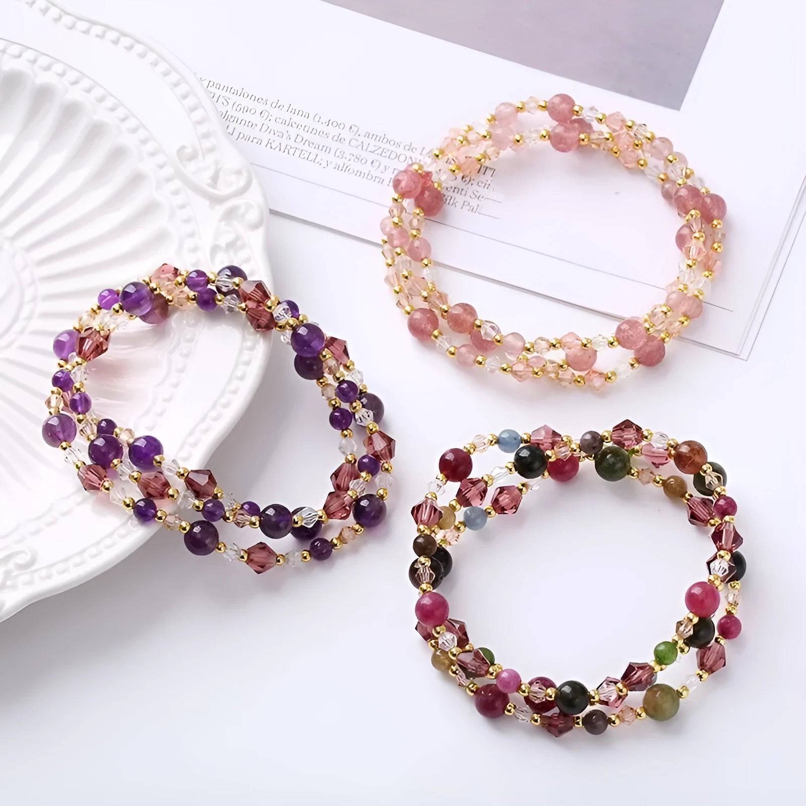 Close-up of a women's hand-made three-ring crystal bracelet with colourful beads on an adjustable rope.