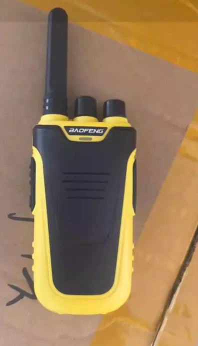 Red and yellow hotel restaurant intercom pager showing compact 95mm size with USB charging port