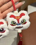 Blue and yellow handmade plush lion keychain ornaments with star stone decoration on white background.
