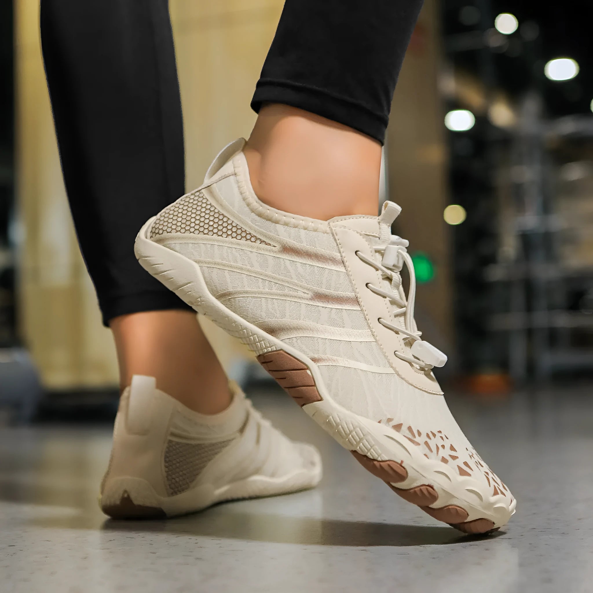 Lycra stretch fabric casual running shoes for men and women on a beach background.