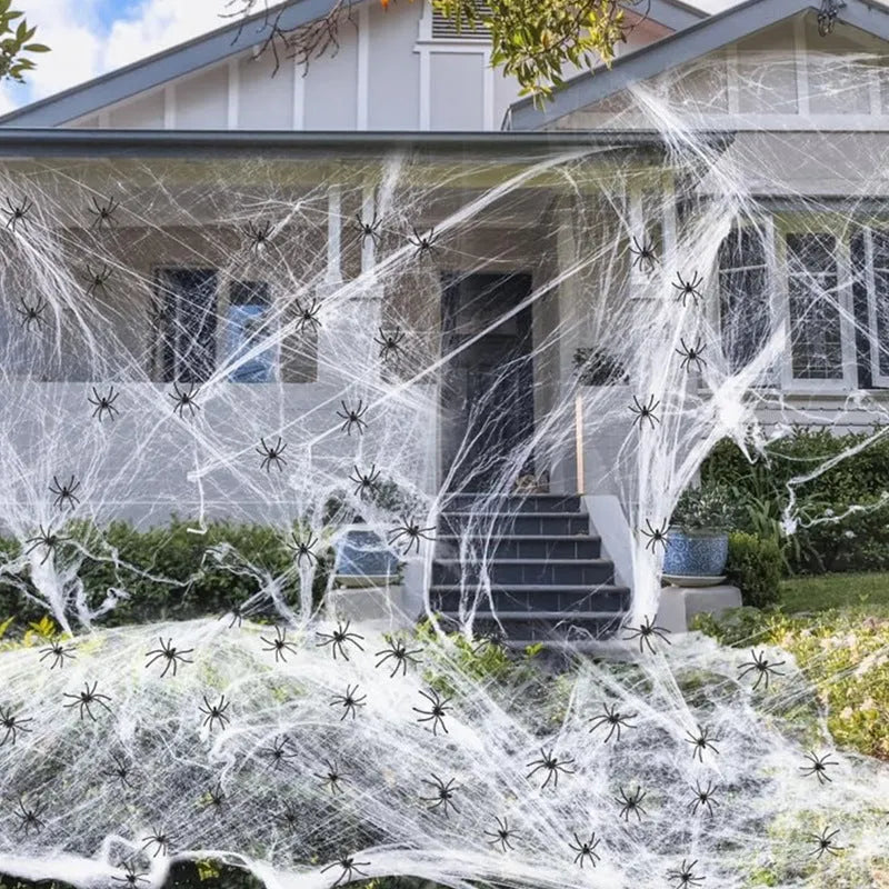 White cotton spider web Halloween decoration with plastic spiders for party or haunted house atmosphere