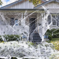 White cotton spider web Halloween decoration with plastic spiders for party or haunted house atmosphere