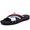 Men's white cowhide leather flip-flop sandals with a non-slip PU sole on a beach background.